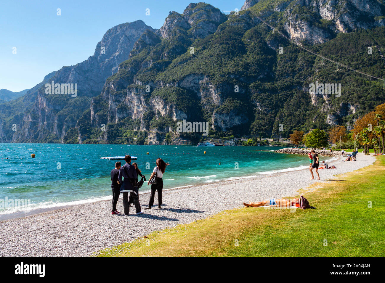 Tourists by lake, Riva del Garda, Trentino, Alto Adige, Northern Italy Stock Photo