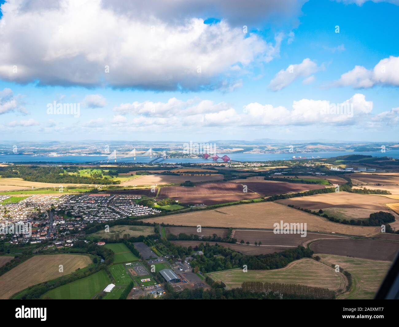 View from plane window of three bridges across Firth of Forth, Scotland, UK with Queensferry Crossing, Forth Rail Bridge & Forth Road Bridge Stock Photo