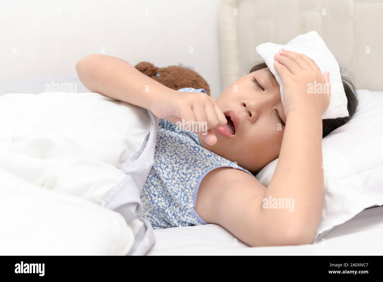 Sick girl is coughing and sore throat lying on bed, Health care concept Stock Photo Alamy