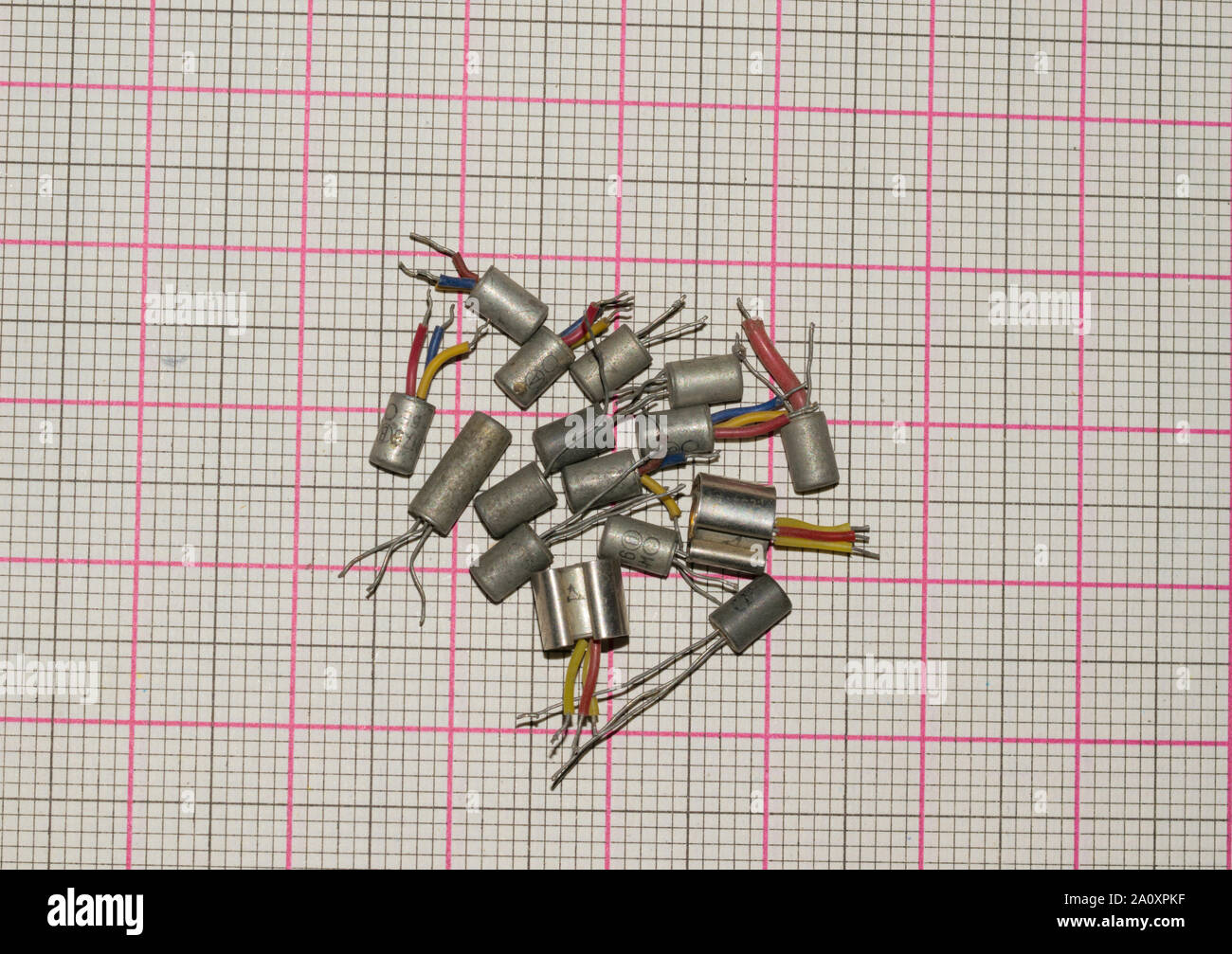 different types of old germanium transistors isolated on a graph paper