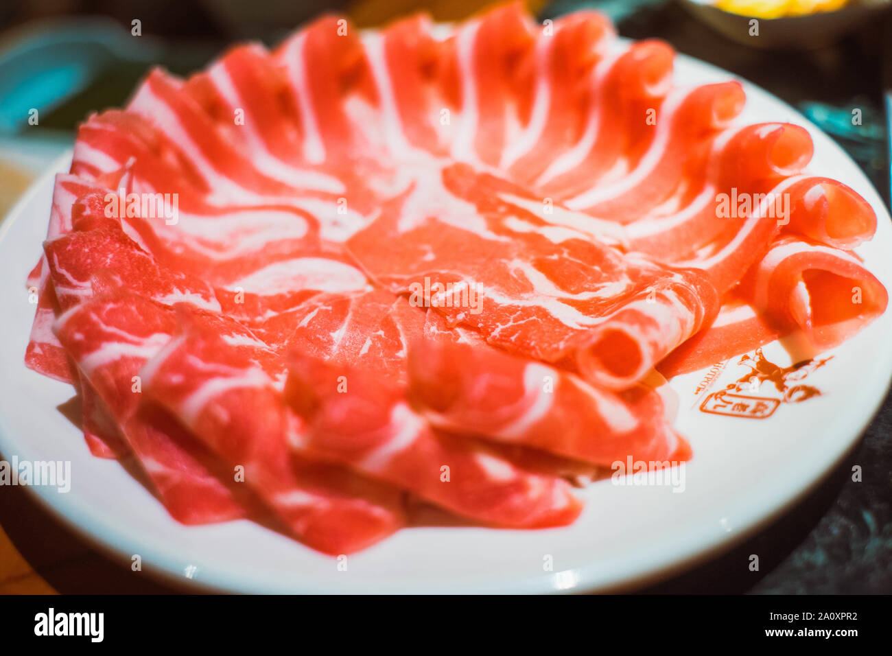 beef slices for Chinese hot pot, with boiling mala spicy soup Stock Photo