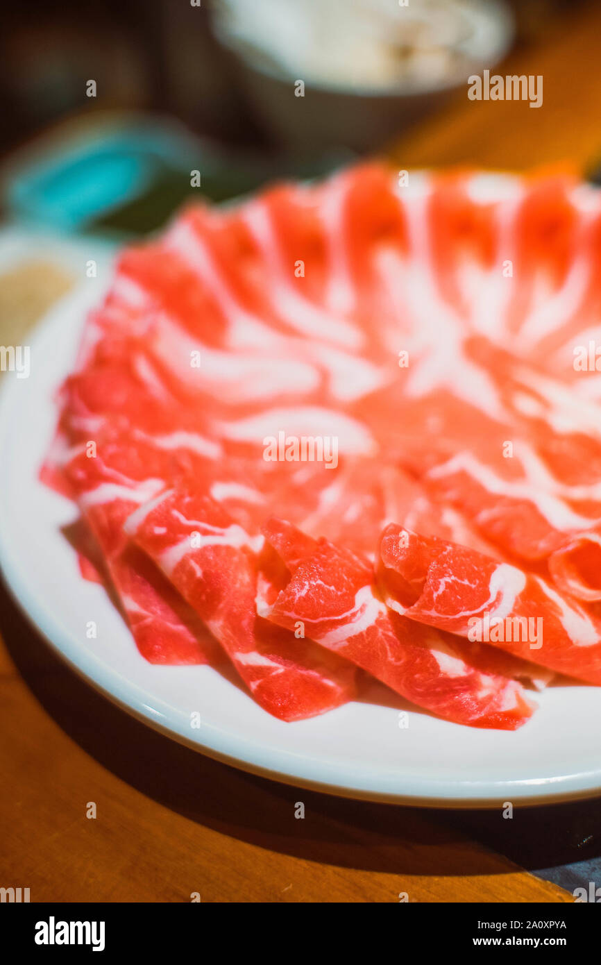 beef slices for Chinese hot pot, with boiling mala spicy soup Stock Photo Alamy
