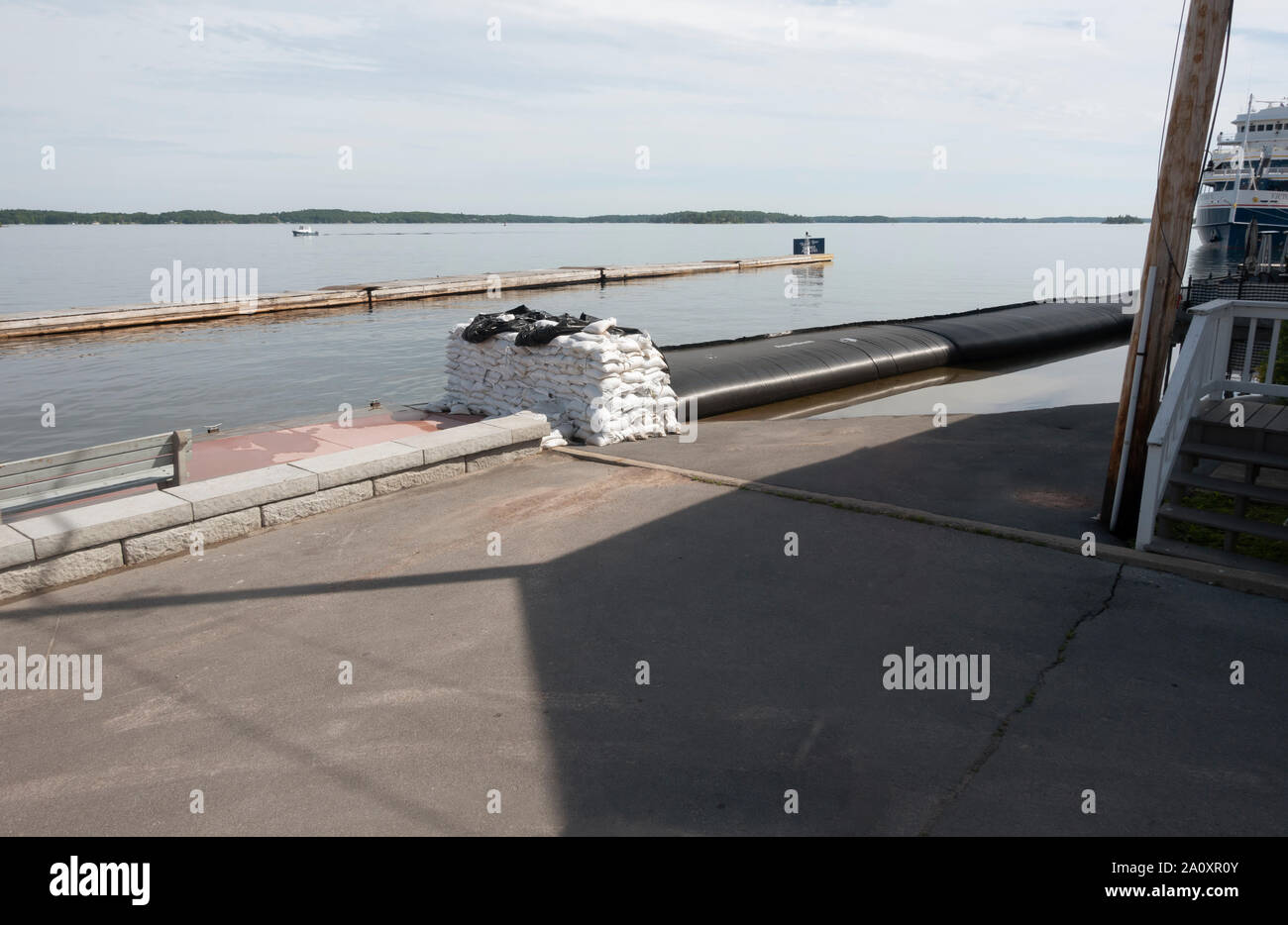 Flood control during high water in 2019, Clayton, New York include sandbags and Aquadam, a water filled barrier. Stock Photo
