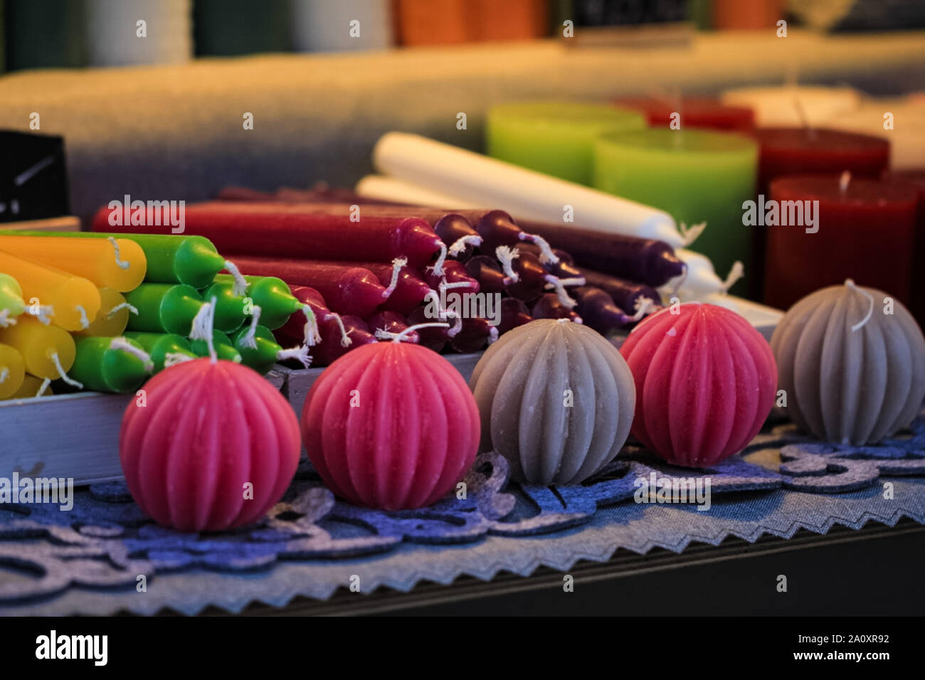 Handmade candles different forms and colors standing and lying on the table Stock Photo