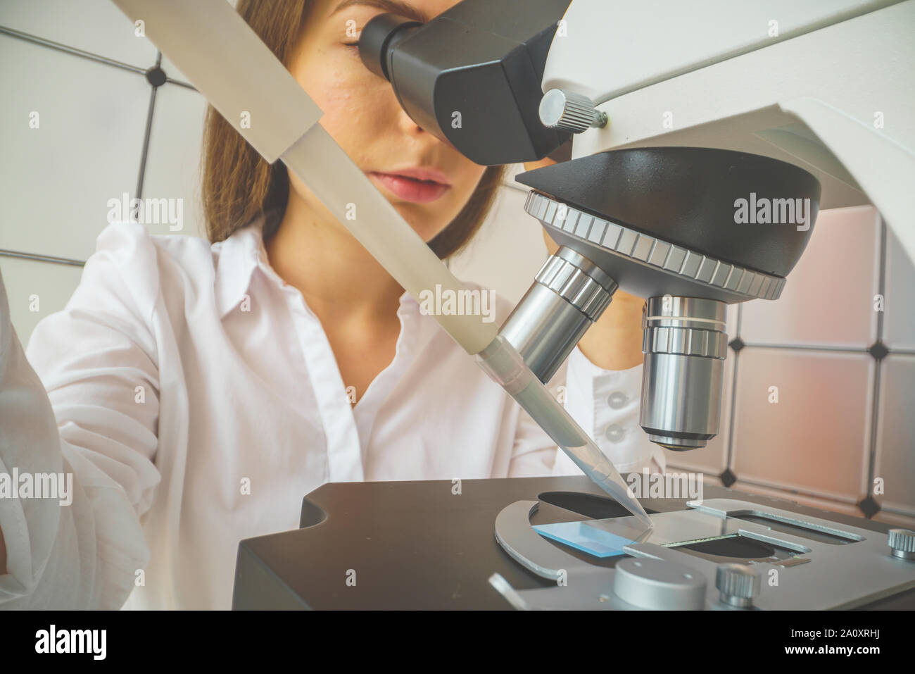 student girl looking in a microscope, science laboratory concept Stock ...