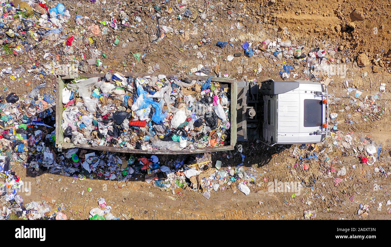 Loaded Garbage Trucks unloading at a Municipal landfill, Top down