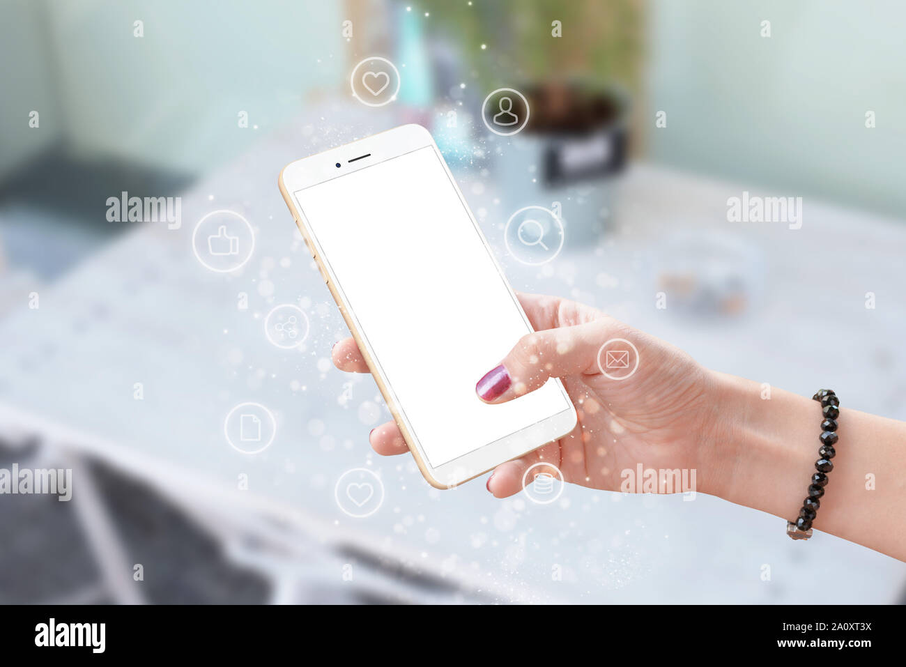 Phone in woman hand surrounded with social network icons. Isolated screen for mockup. Stock Photo