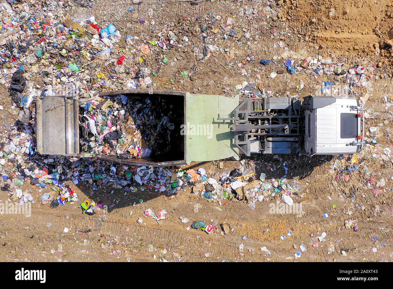 Loaded Garbage Trucks unloading at a Municipal landfill, Top down