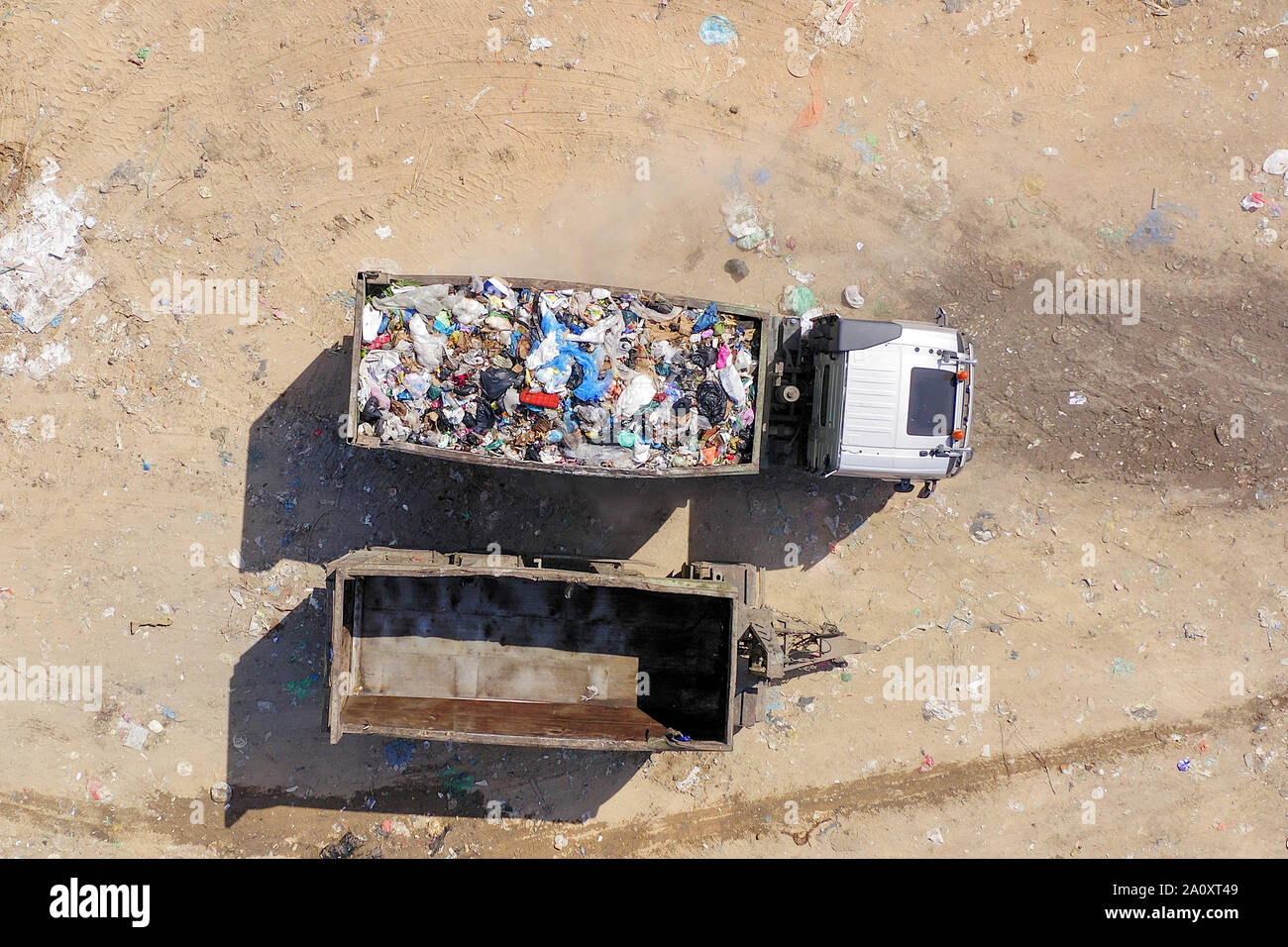 Loaded Garbage Trucks unloading at a Municipal landfill, Top down