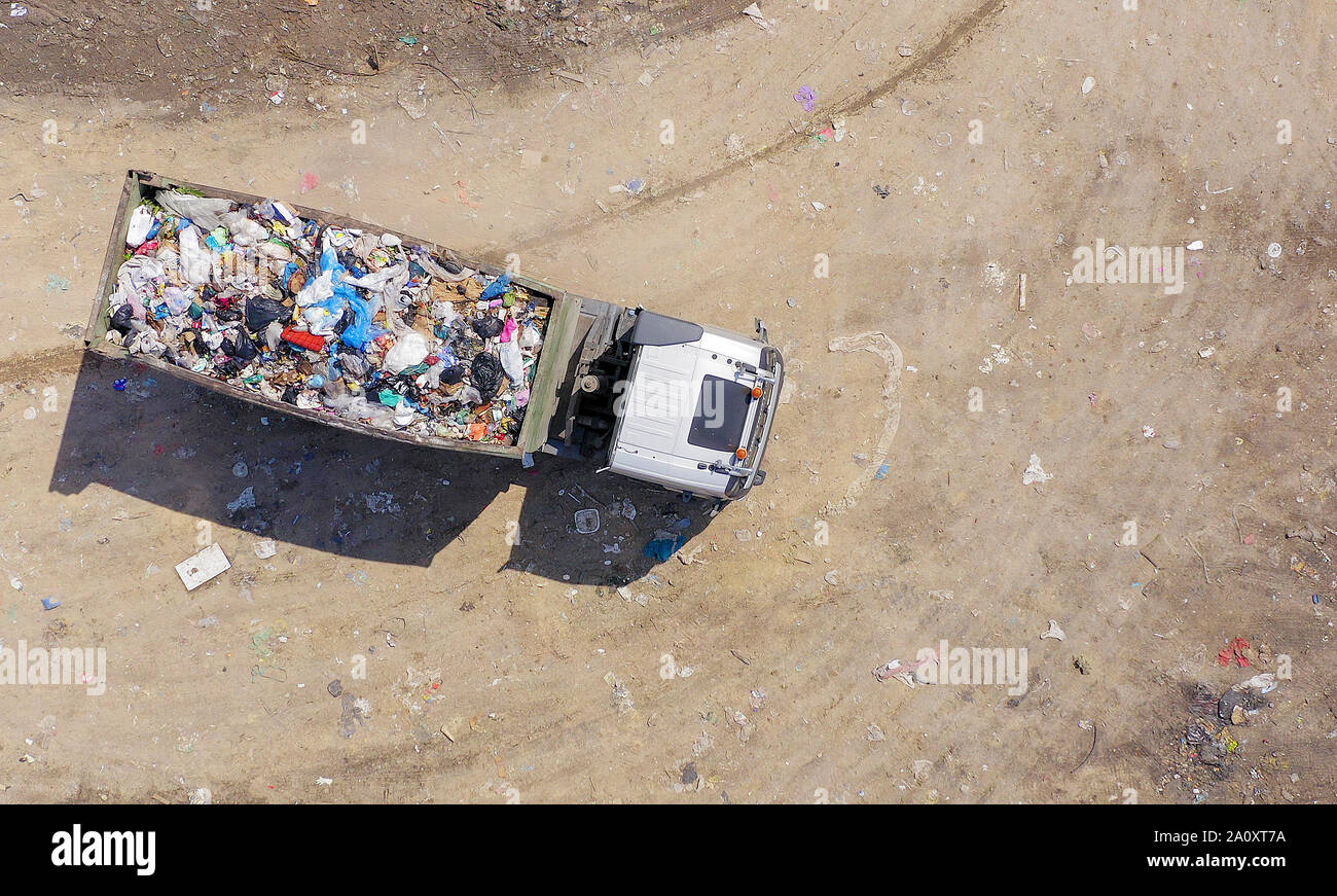 Loaded Garbage Trucks unloading at a Municipal landfill, Top down aerial Stock Photo