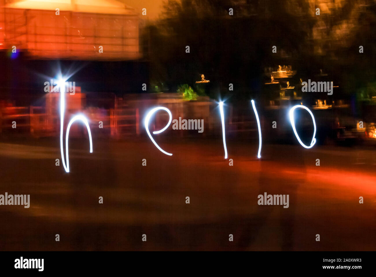 The word 'hello' written in torchlight using a long exposure after dark Stock Photo