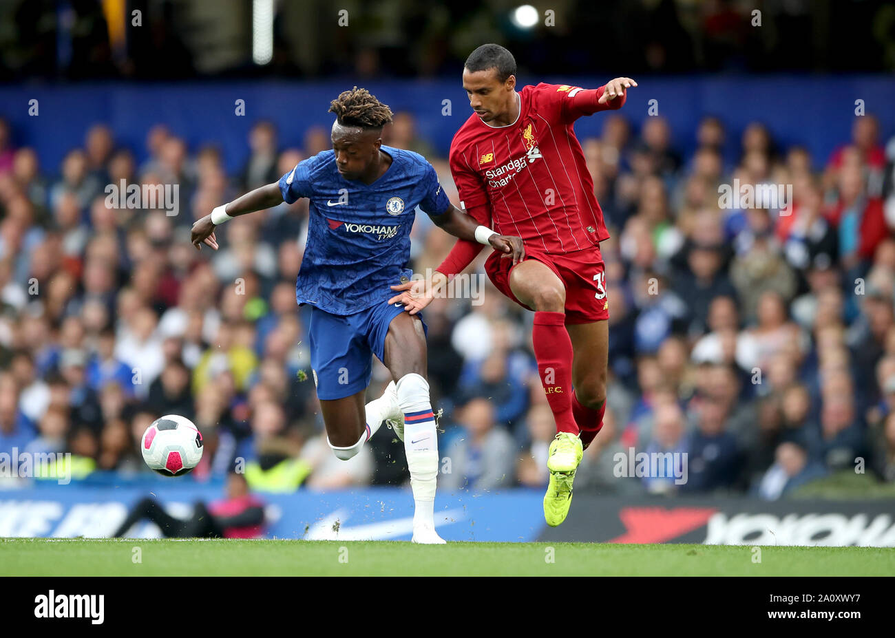 Chelsea's Tammy Abraham (left) and Liverpool's Joel Matip (right) battle for the ball during the Premier League match at Stamford Bridge, London. Stock Photo