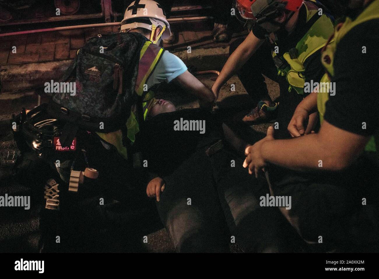 Paramedics help a fainted demonstrator during the protests.Protesters continue to demonstrate across Hong Kong for the 15th consecutive week. Demonstration were held inside a shopping mall in Yuen Long against the government. Stock Photo