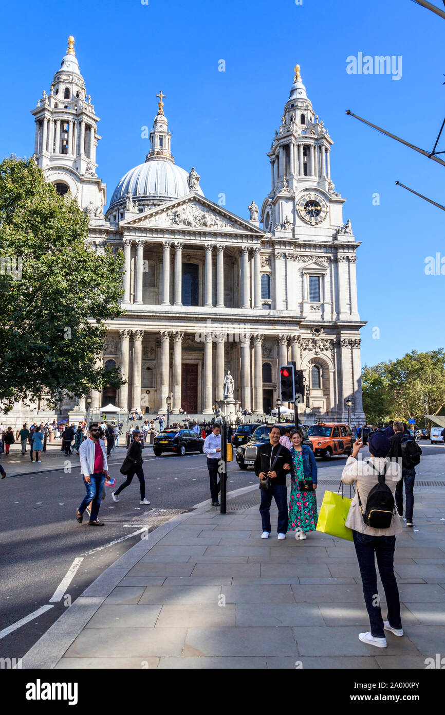 Tourists taking photographs in front of St Paul's Cathedral, London, UK Stock Photo