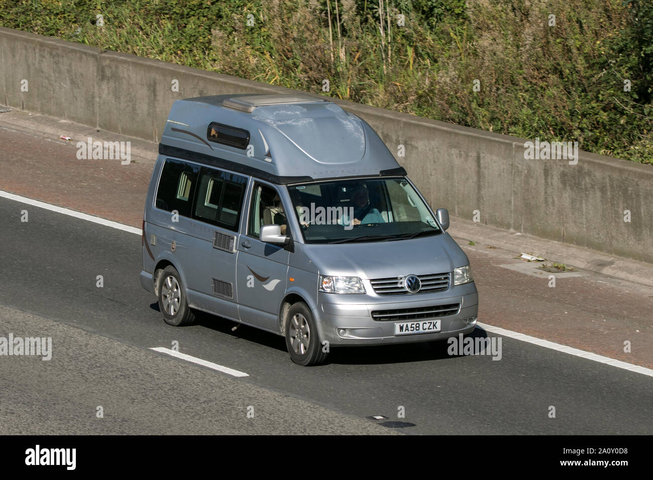 A VW Volkswagen campervan traveling northbound on the M6 motorway near