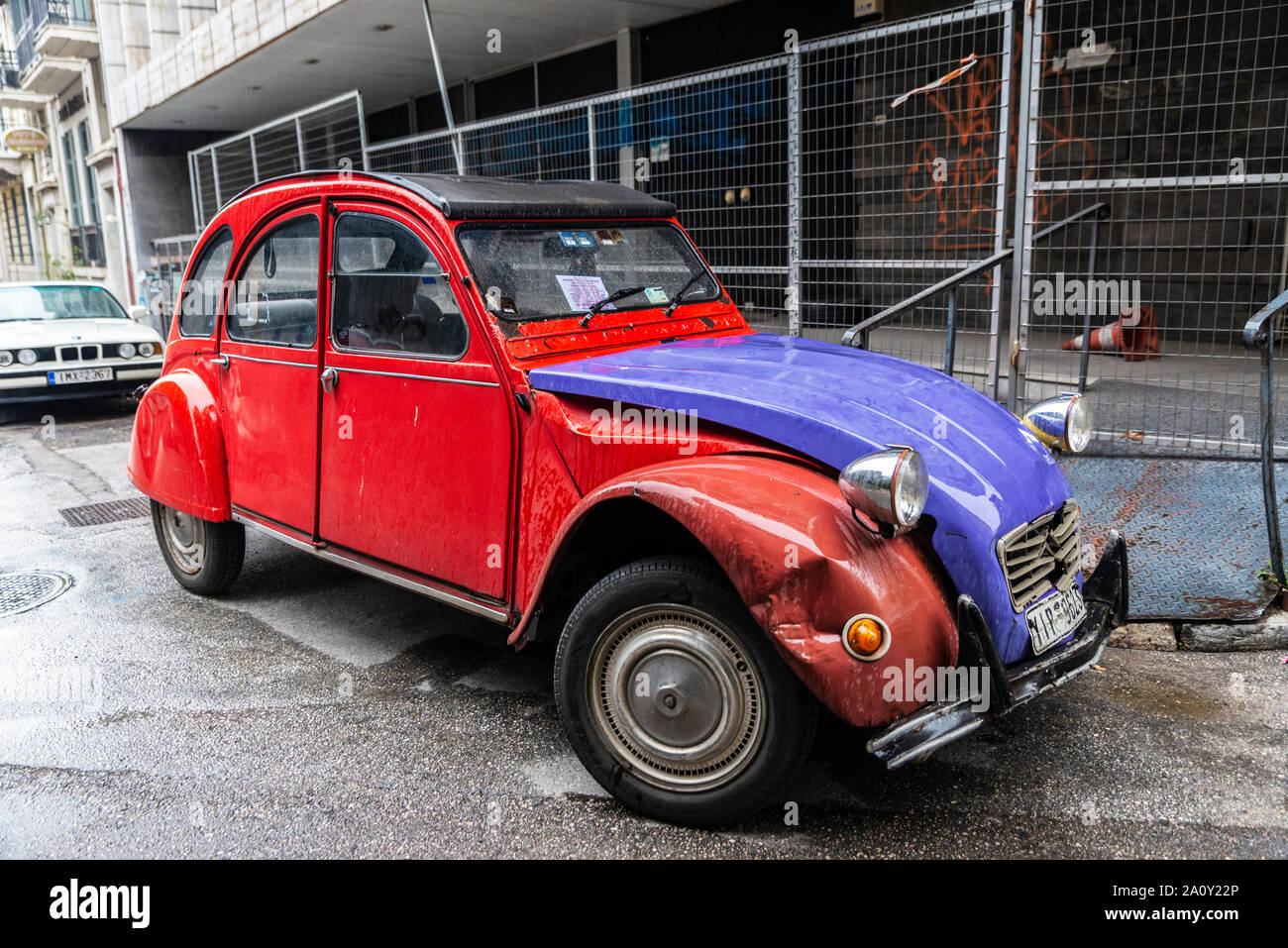 Athens, Greece - December 31, 2018: Red and blue Citroen 2CV (two steam horses or two tax horsepower) car parked on a street in Athens, Greece Stock Photo