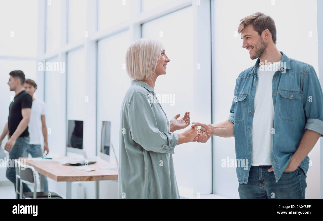 two designers discuss sketches standing in a spacious office Stock Photo