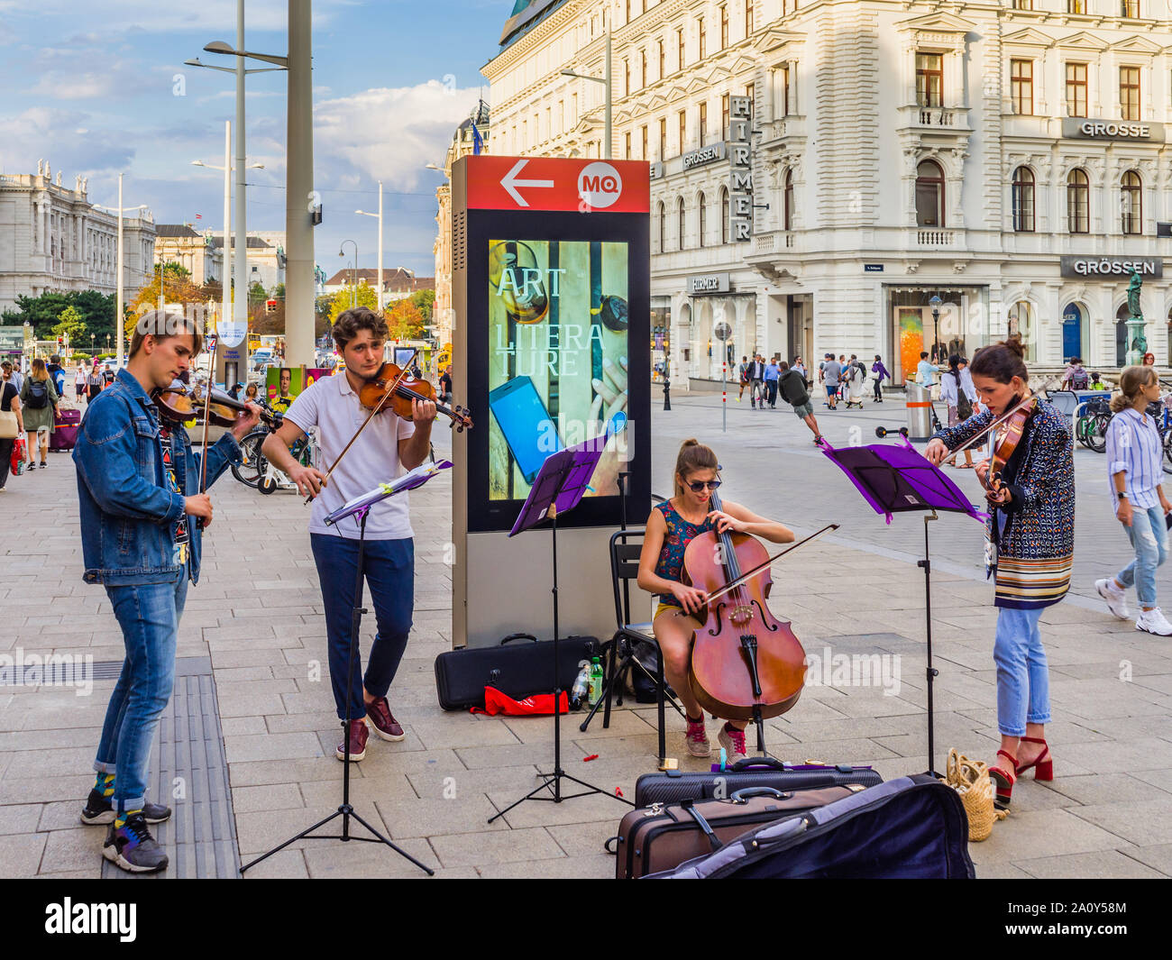 Young classical music school students playing on busy street in Vienna, Austria. Stock Photo