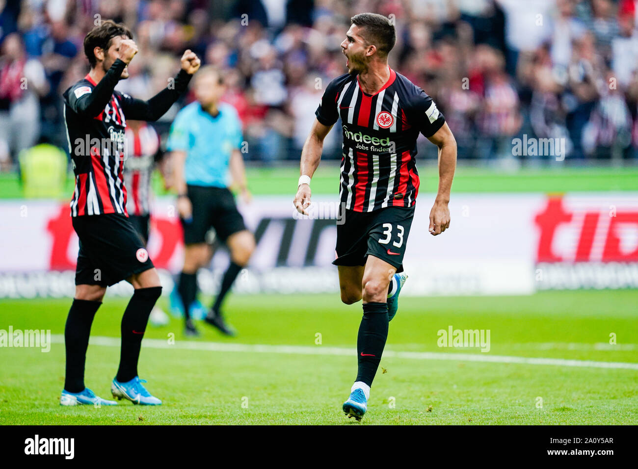 22 September 2019, Hessen, Frankfurt/Main: Soccer: Bundesliga, Eintracht Frankfurt - Borussia Dortmund, 5th matchday, in the Commerzbank Arena. Frankfurt's goal scorer Andre Silva (r) cheers over the goal to 1:1 alongside Goncalo Paciencia. Photo: Uwe Anspach/dpa - IMPORTANT NOTE: In accordance with the requirements of the DFL Deutsche Fußball Liga or the DFB Deutscher Fußball-Bund, it is prohibited to use or have used photographs taken in the stadium and/or the match in the form of sequence images and/or video-like photo sequences. Stock Photo