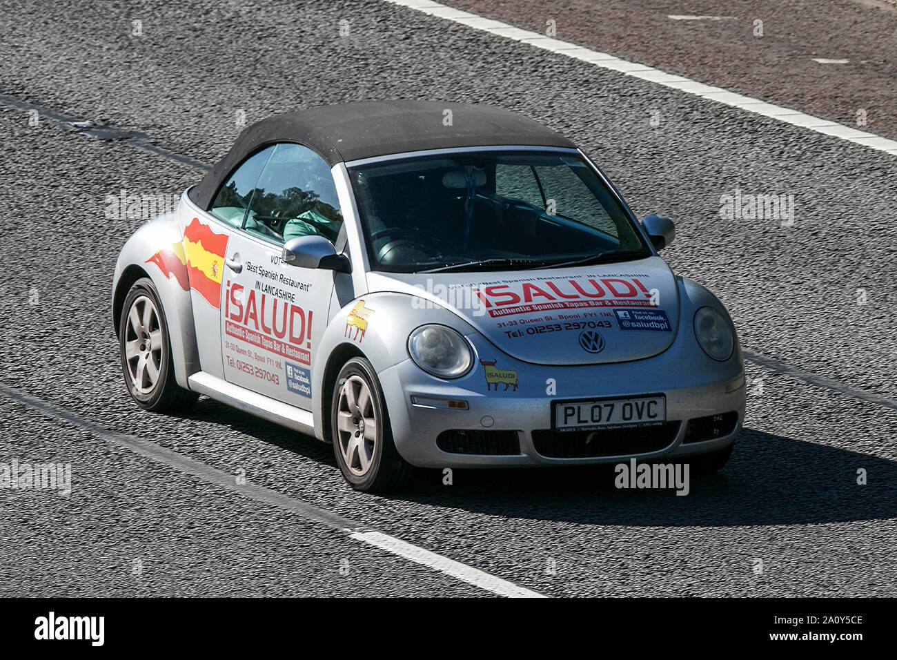 A VW Volkswagen beetle bug traveling northbound on the M6 motorway near Garstang in Lancashire, UK. Stock Photo