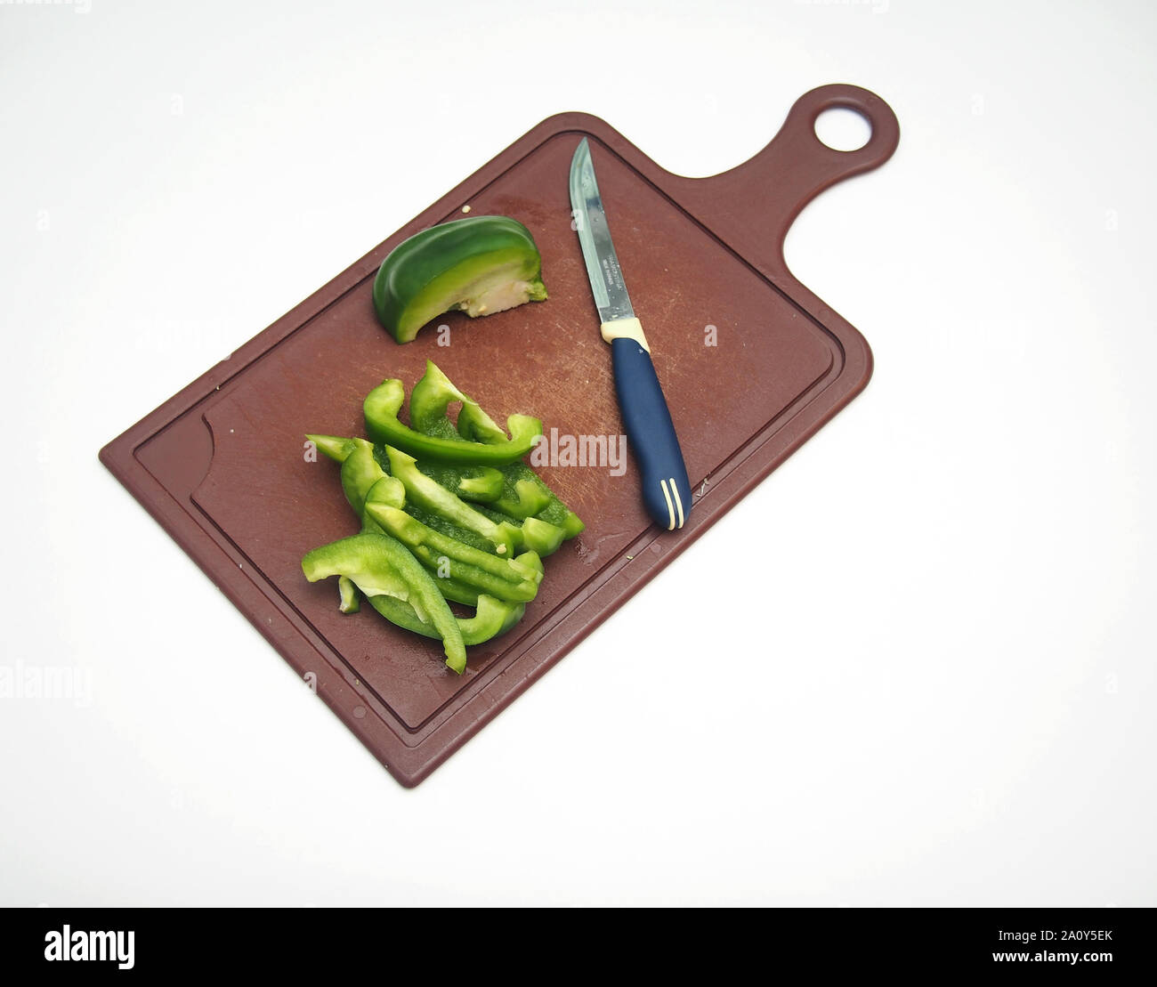 Royalty-Free photo: Avocado fruit on chopping board beside green handled  knife