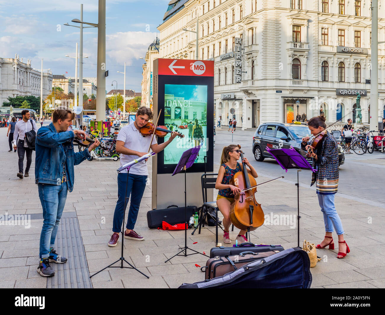 Young classical music school students playing on busy street in Vienna, Austria. Stock Photo