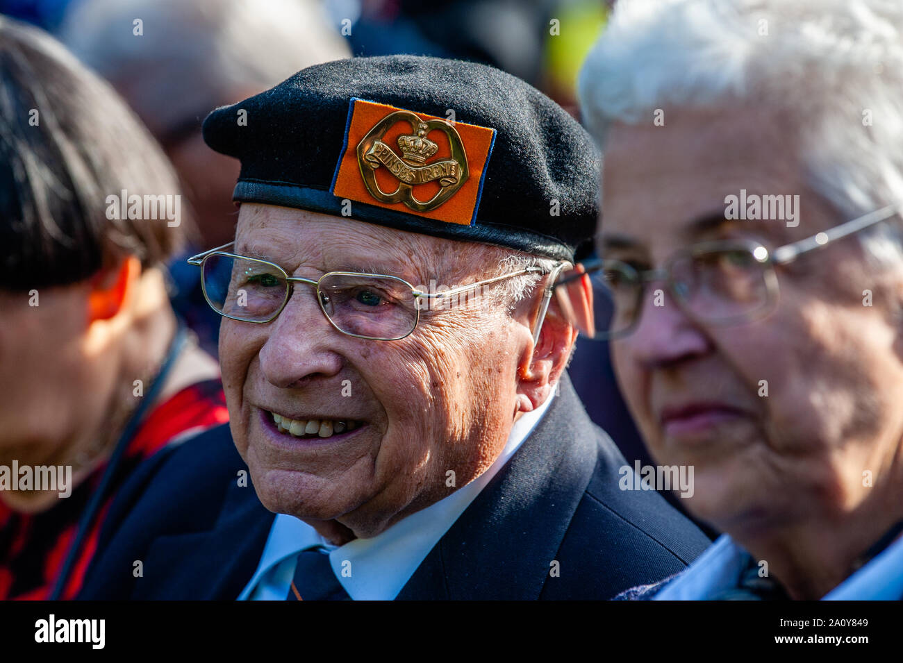 A war veteran smiling during the commemoration.At the Arnhem Oosterbeek War Cemetery, more than 1750 Allied soldiers were buried. As part of the commemorations for the 75th anniversary of Operation Market Garden, a memorial service was held in the presence of veterans, their relatives and thousands of people. A white stone arch was placed at each grave. On the field of honor is a 'Cross of sacrifice' made of Portland stone, on which a bronze sword is attached. Stock Photo