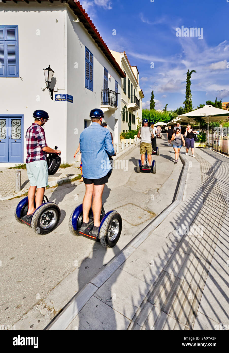 Tourists on segways,  two-wheeled, personal transporters, in Monastiraki area outside of Roman forum in Athens, Greece. Stock Photo