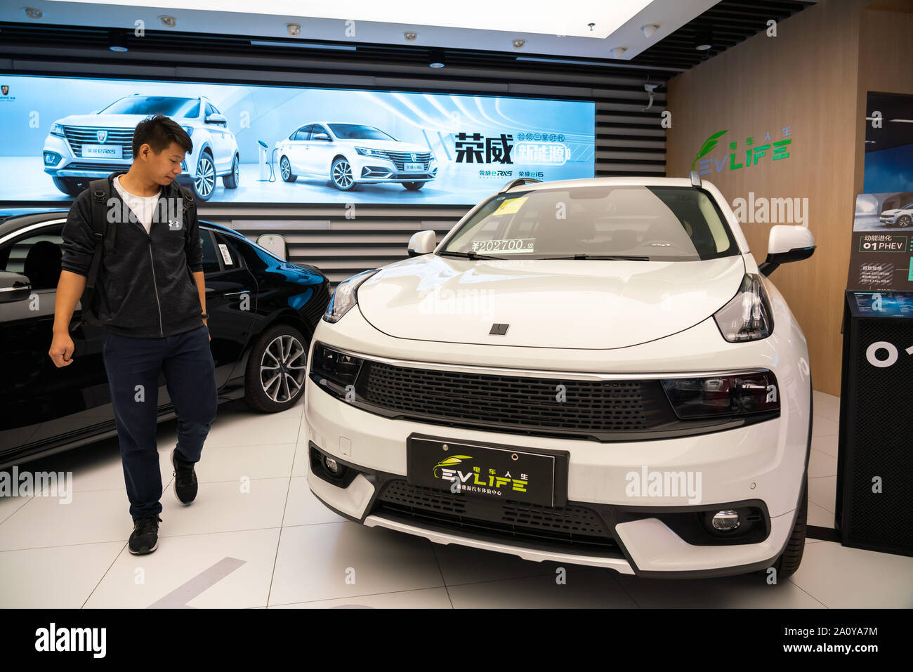 Customer looks at a Lynk & Co hybrid SUV at an electric and hybrid cars retailer in Shanghai. Stock Photo