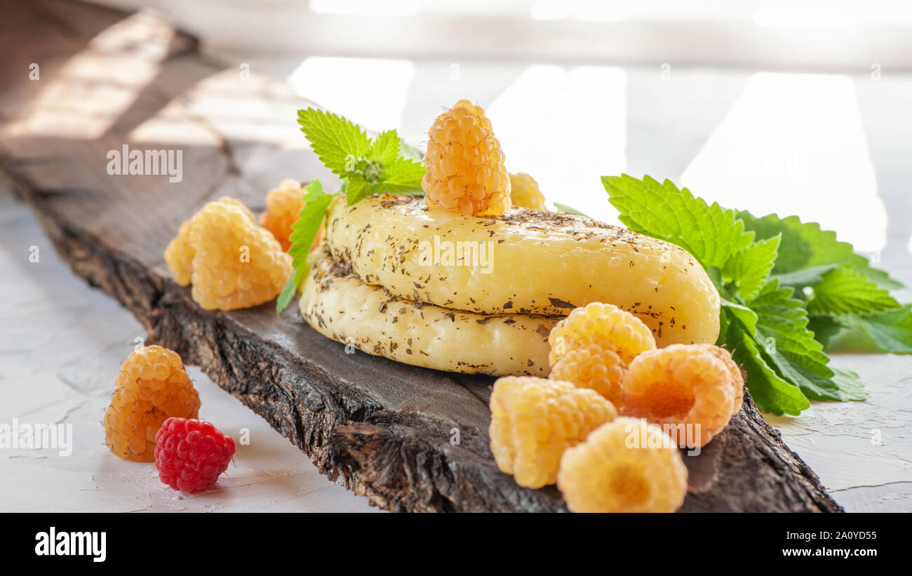 Halloumi cheese with yellow raspberries. Unconventional serving of halloumi cheese. Farm natural product. Stock Photo