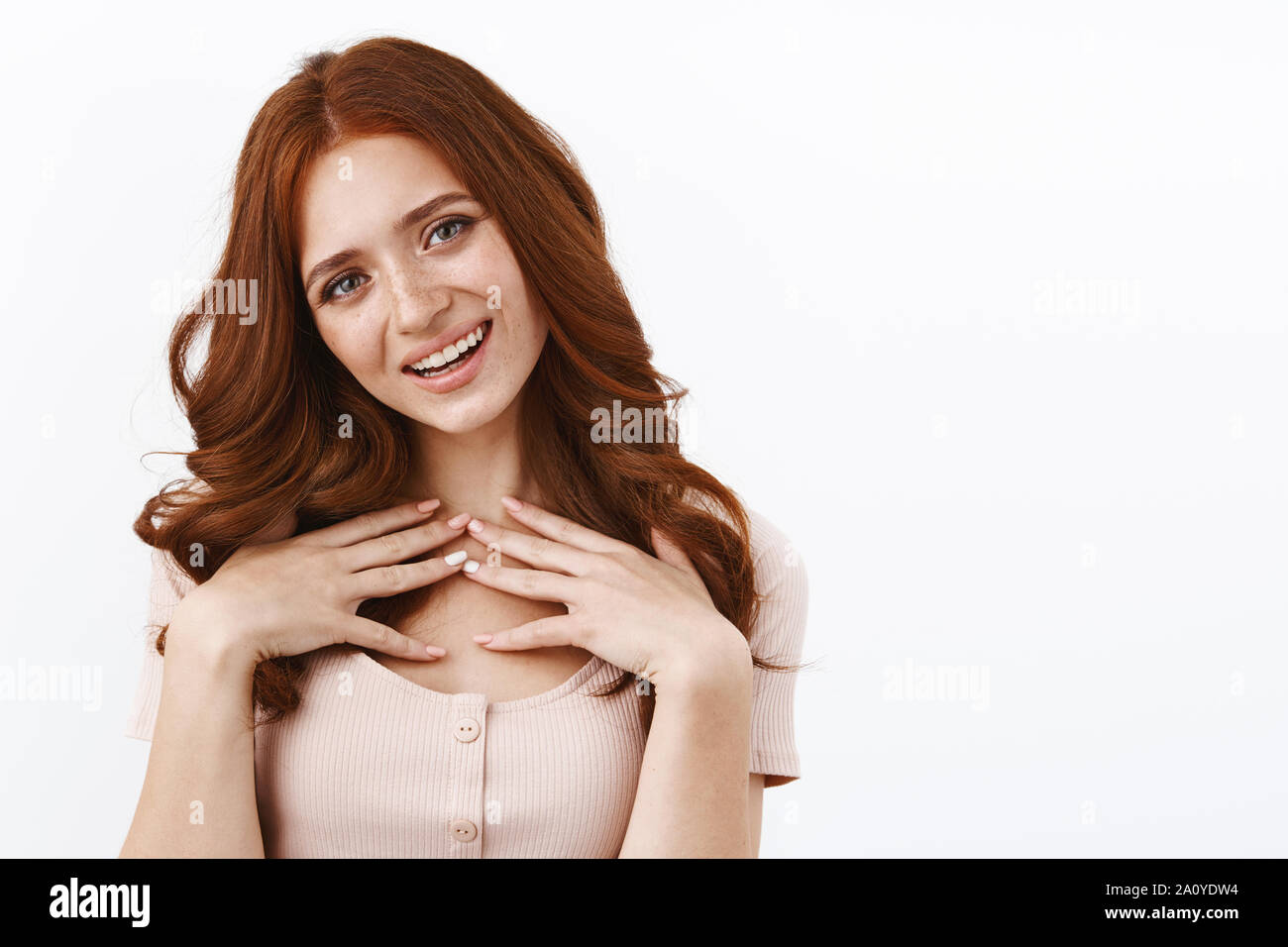 Touched cute coquettish redhead girl in blouse, touching chest grateful and pleased, tilt head, thanking for lovely compliment, feeling flattered and Stock Photo