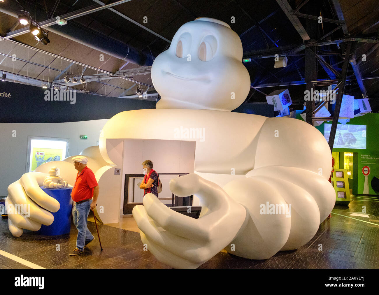 Huge Michelin Tyre Man (bibendum) forming entrance to first floor of L'Aventure Michelin museum in Clermont Ferrand, France Stock Photo