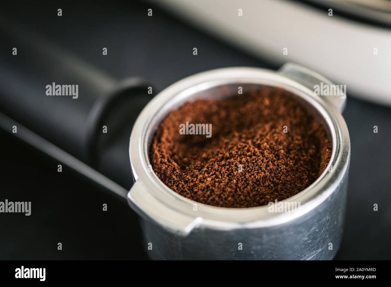 Ground black coffee in portafilter for espresso coffee machine Stock