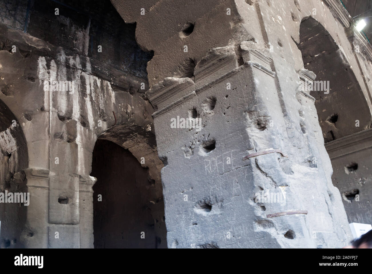 Holes in Colosseum where iron clamps were stolen after the decline of
