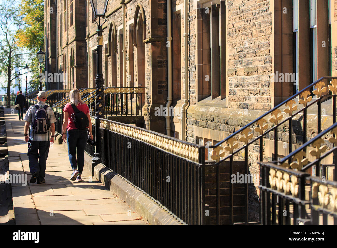 Two tourists take in the sights at Professors Square in the grounds of Glasgow University Stock Photo