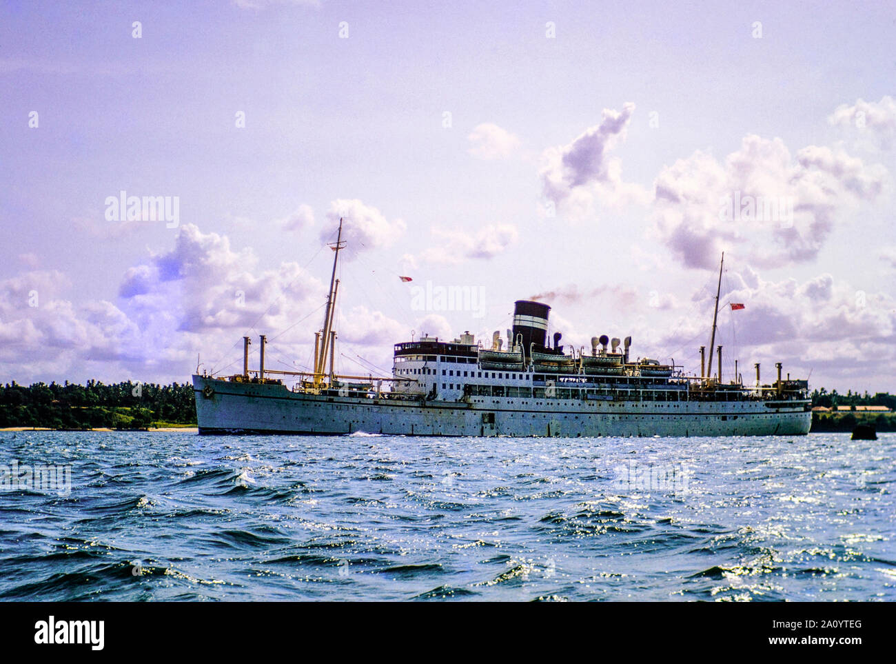The former WW11 hospital ship HMS AMRA sailing into the Port of Aden in the Yemen in 1960. She was originally built for the British India Steam Navigation Company Ltd of Calcutta in November 1938, for use on its Calcutta-Rangoon service. She was requisitioned by the British Government as a troop carrier and hospital ship for the duration of the war. Following the war she was used by the Indian government for the transportation of freight and passengers on the East African route, before eventually being broken up in 1961. Stock Photo