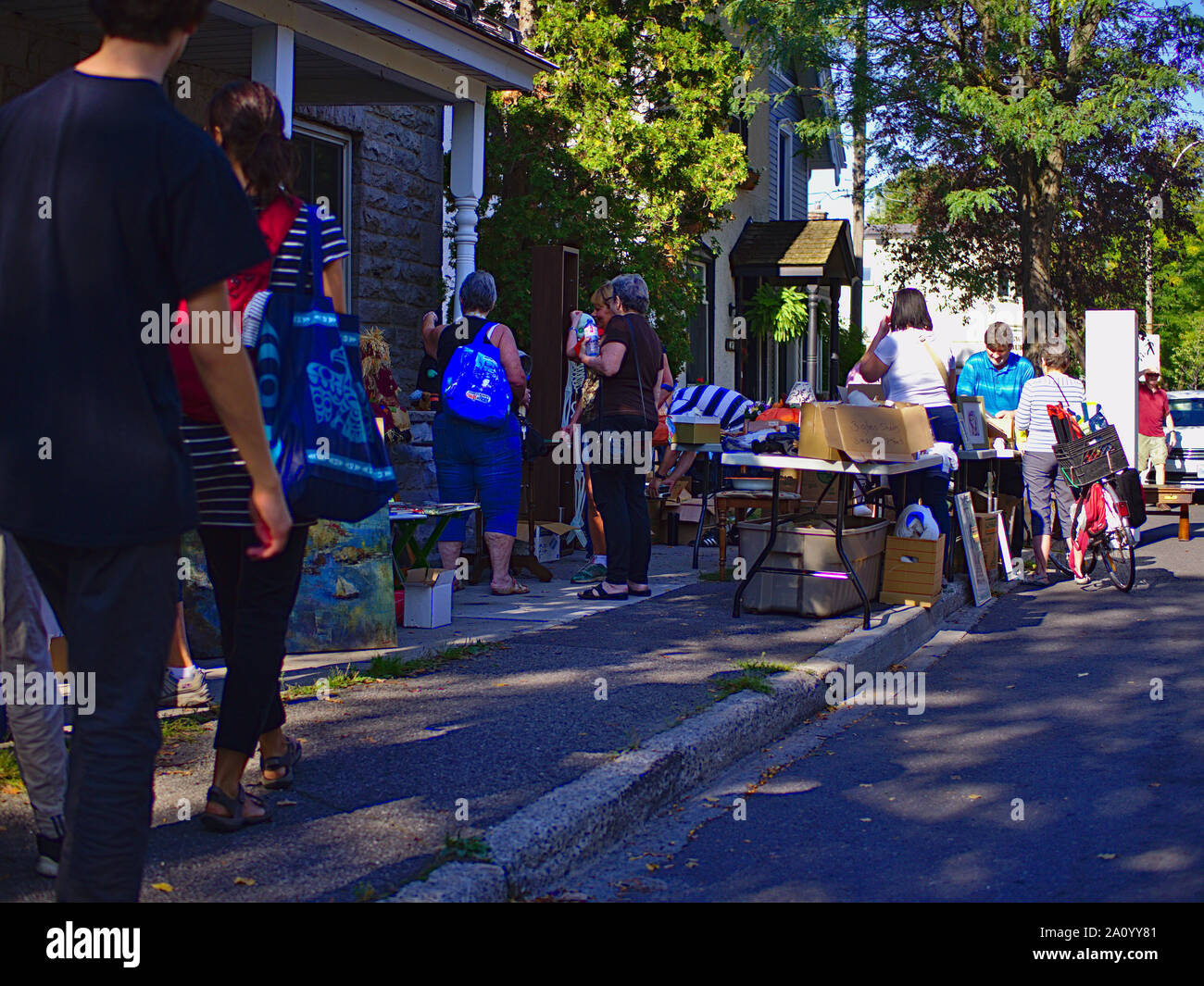 People browsing stalls in front of houses at the New Edinburgh garage