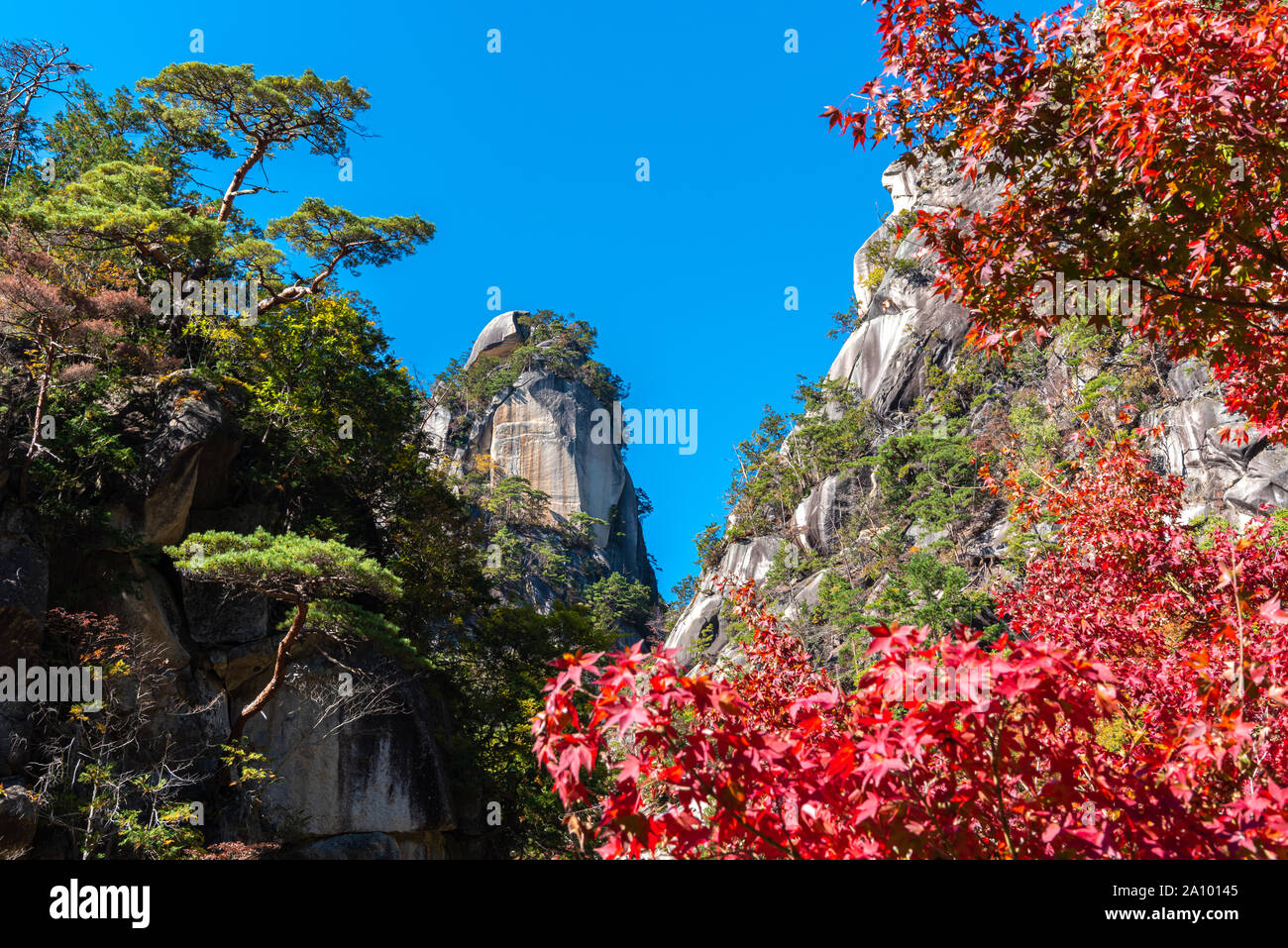 Rock Kakuenbou, a massive rocky mountain. Symbol of Mitake Shosenkyo Gorge. A popular tourist attractions. Autumn foliage scenery view in sunny day. Stock Photo