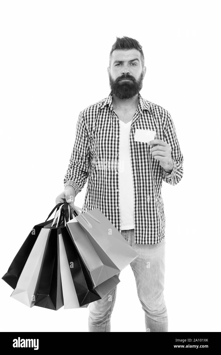 Cyber Monday is the biggest shopping day. Shopper holding paper bags and card on Cyber Monday. Hipster paying with credit card on Cyber Monday. Bearded man shopping online on Cyber Monday, copy space. Stock Photo