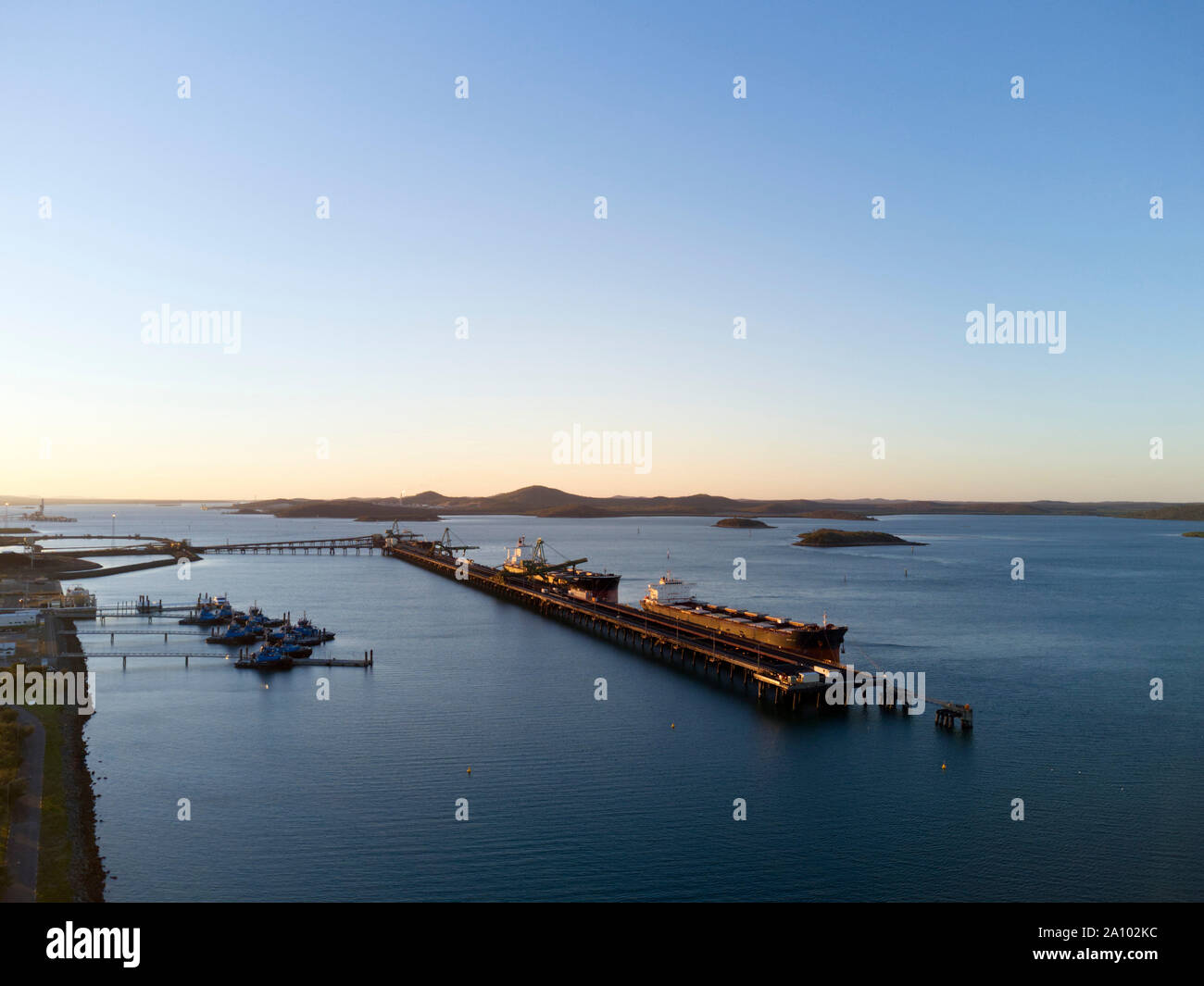 Aerial of bulk carrier ships being loaded with export coal from the RG Tanna Coal Terminal at Gladstone Queensland Australia Stock Photo