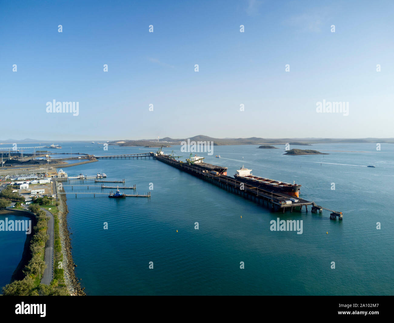 Aerial of bulk carrier ships being loaded with export coal from the RG Tanna Coal Terminal at Gladstone Queensland Australia Stock Photo