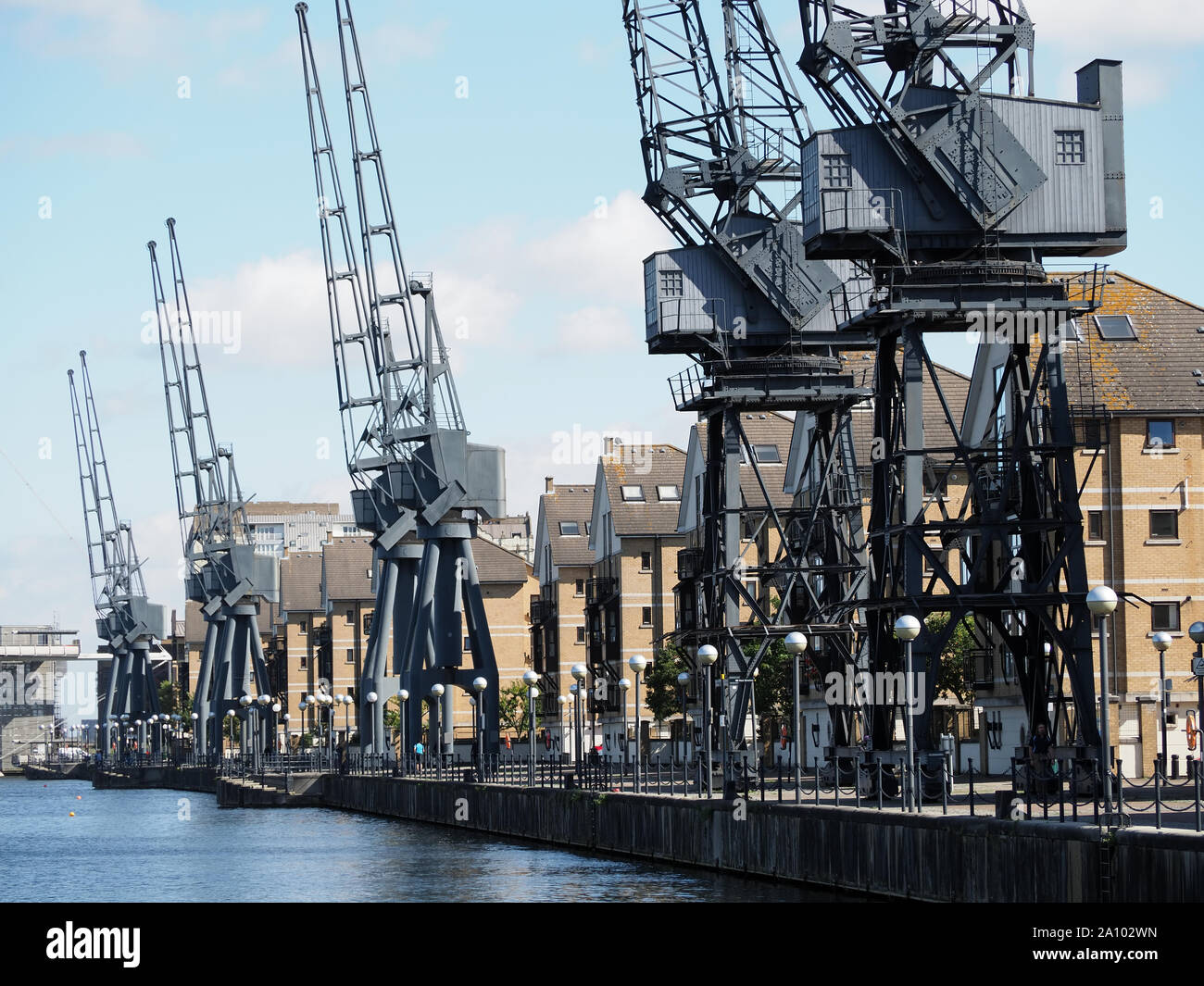 View of a row of cranes on the south side of the Royal Victoria Docks in London Stock Photo