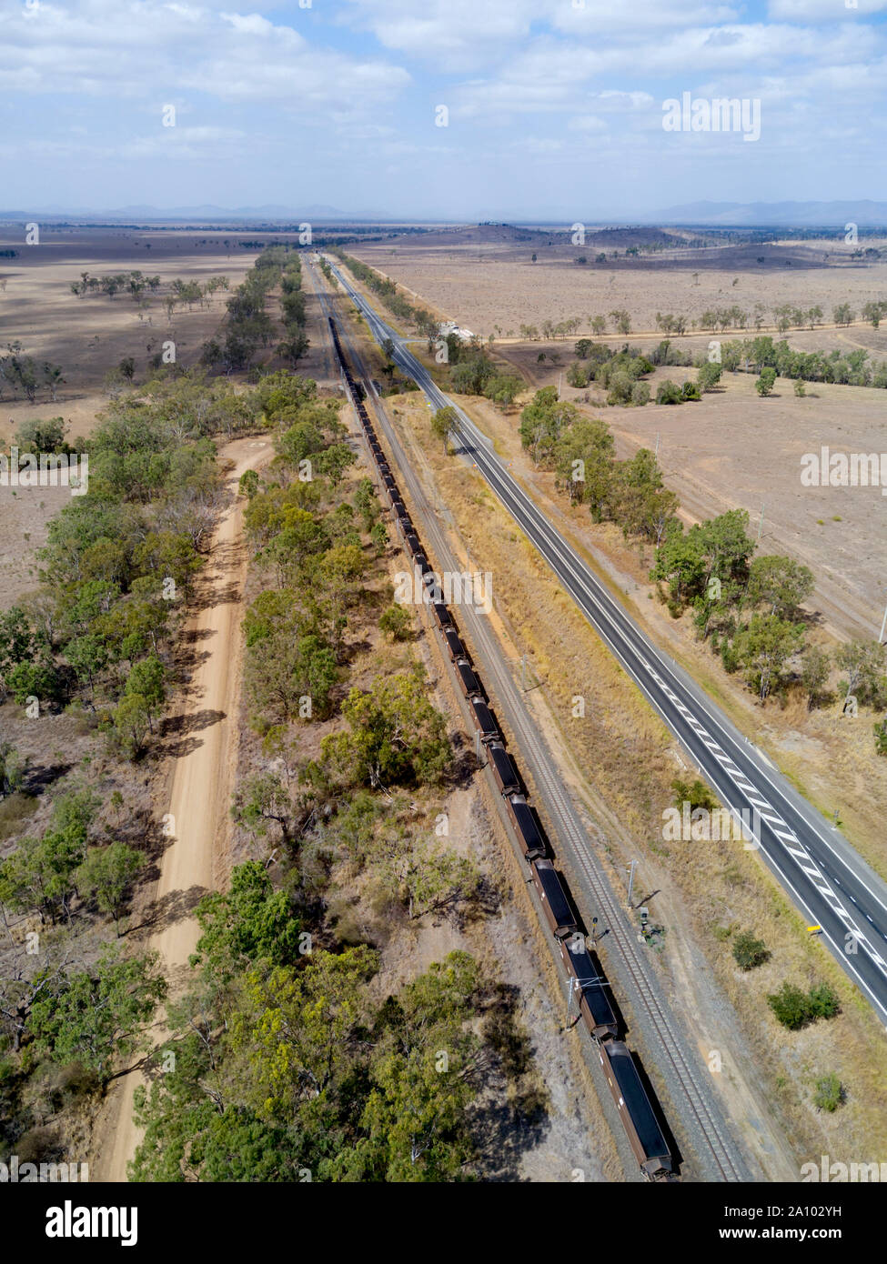 Aerial of Coal Train travelling along side the Bruce Highway to