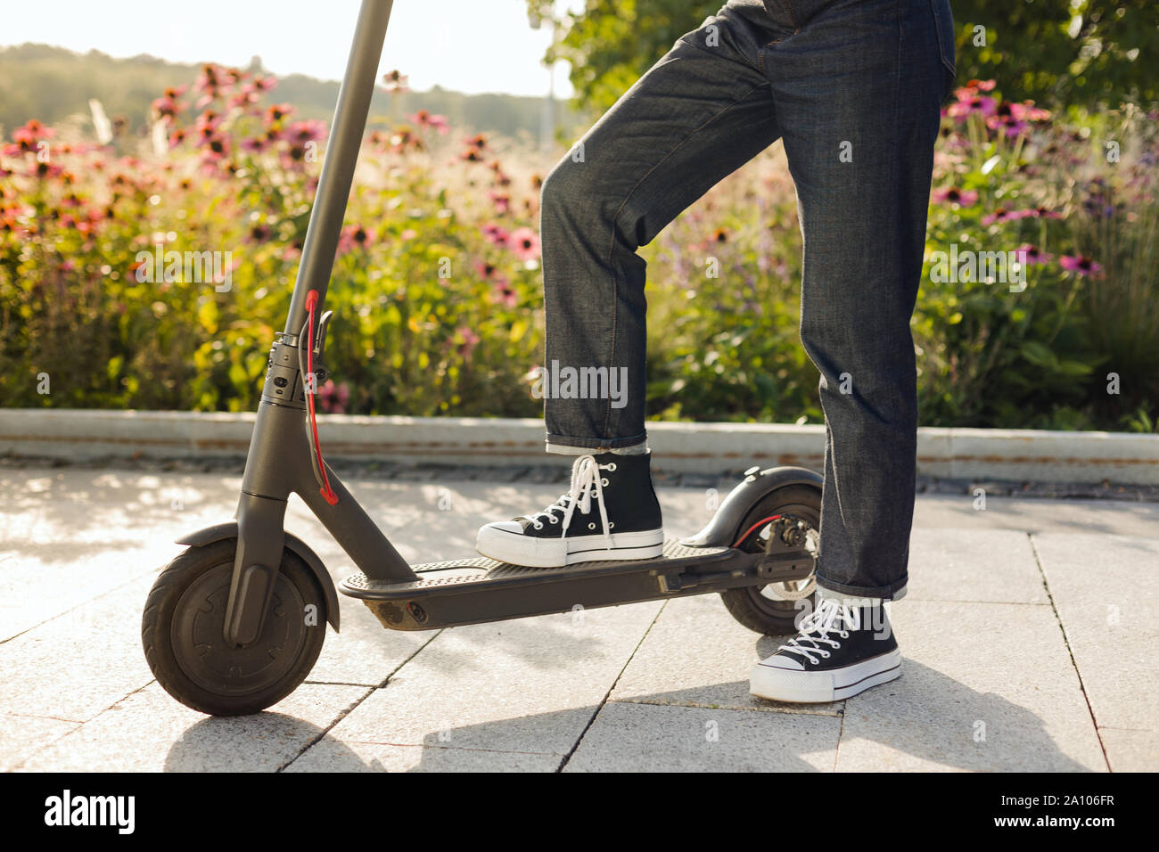 girl riding an ecofriendly electric kick scooter in a park in