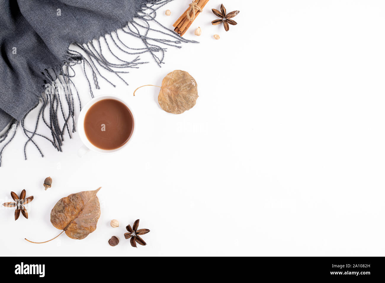 Autumn composition. Cup of coffee, blanket, autumn leaves on white background. Flat lay, top view copy space. Stock Photo