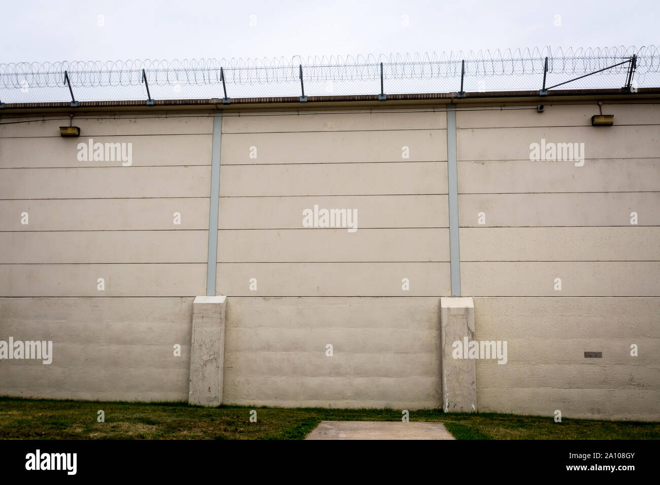 barbed wire on wall in prison yard Kingston Penitentiary a former maximum security prison that opened June 1835 and closed September 2013 Stock Photo