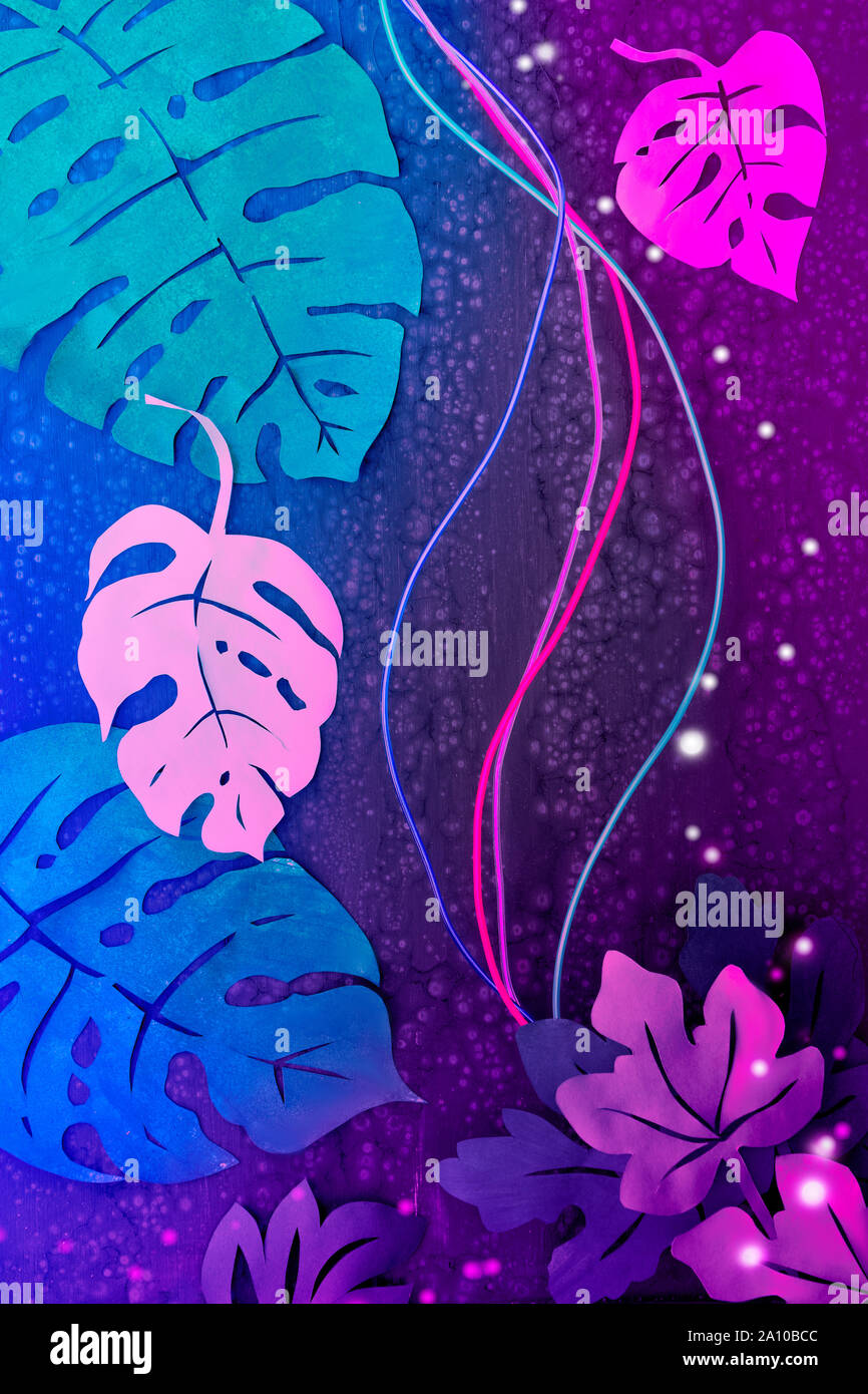 Paper craft background, neon lit vibrant background with light wires and  exotic tropical leaves in glowing pink, purple and blue Stock Photo - Alamy