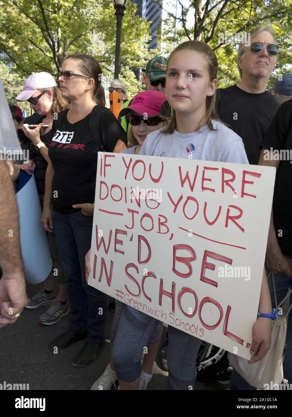 New York City, USA. 20th September, 2019, Climate Strike. Teenager holds sign urging politicians to enact Climate legislation. Stock Photo