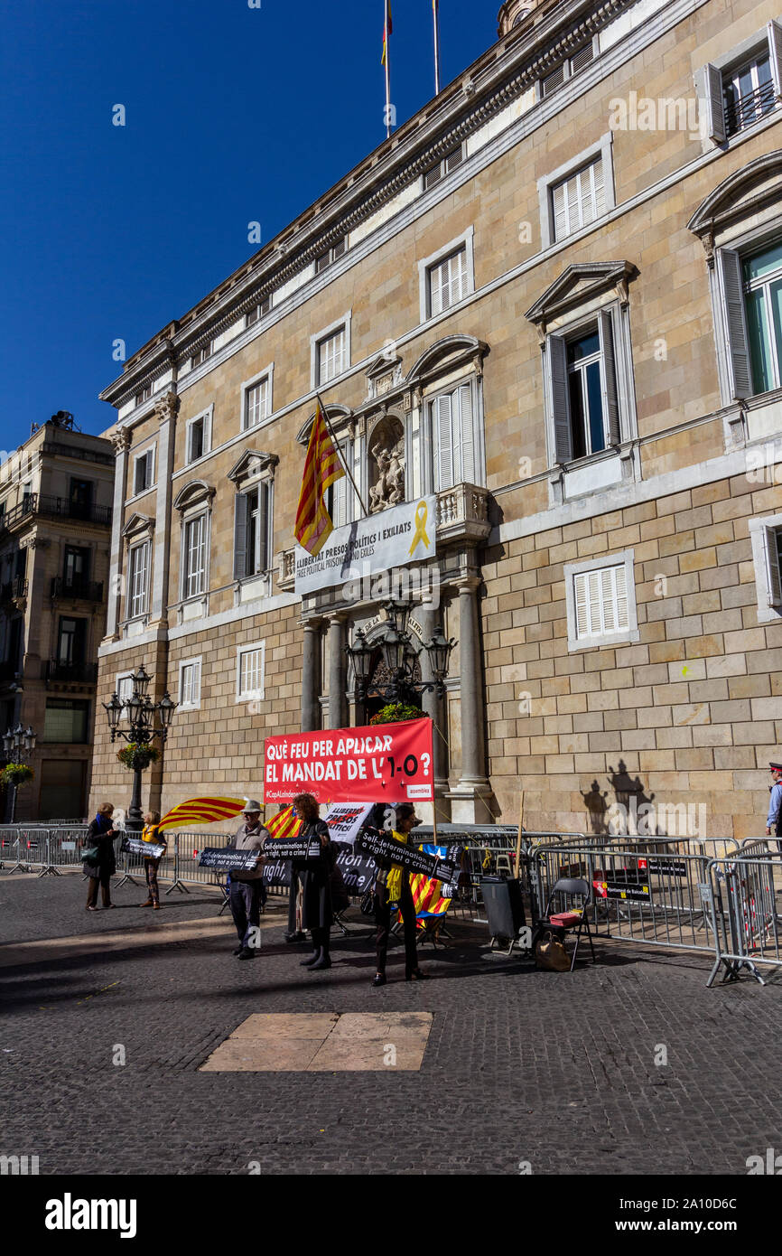 Barcelona, Spain - February 26, 2019 - Protesters gather in front of the Catalonian Government building (Palau de la Generalitat) while tourists pass Stock Photo