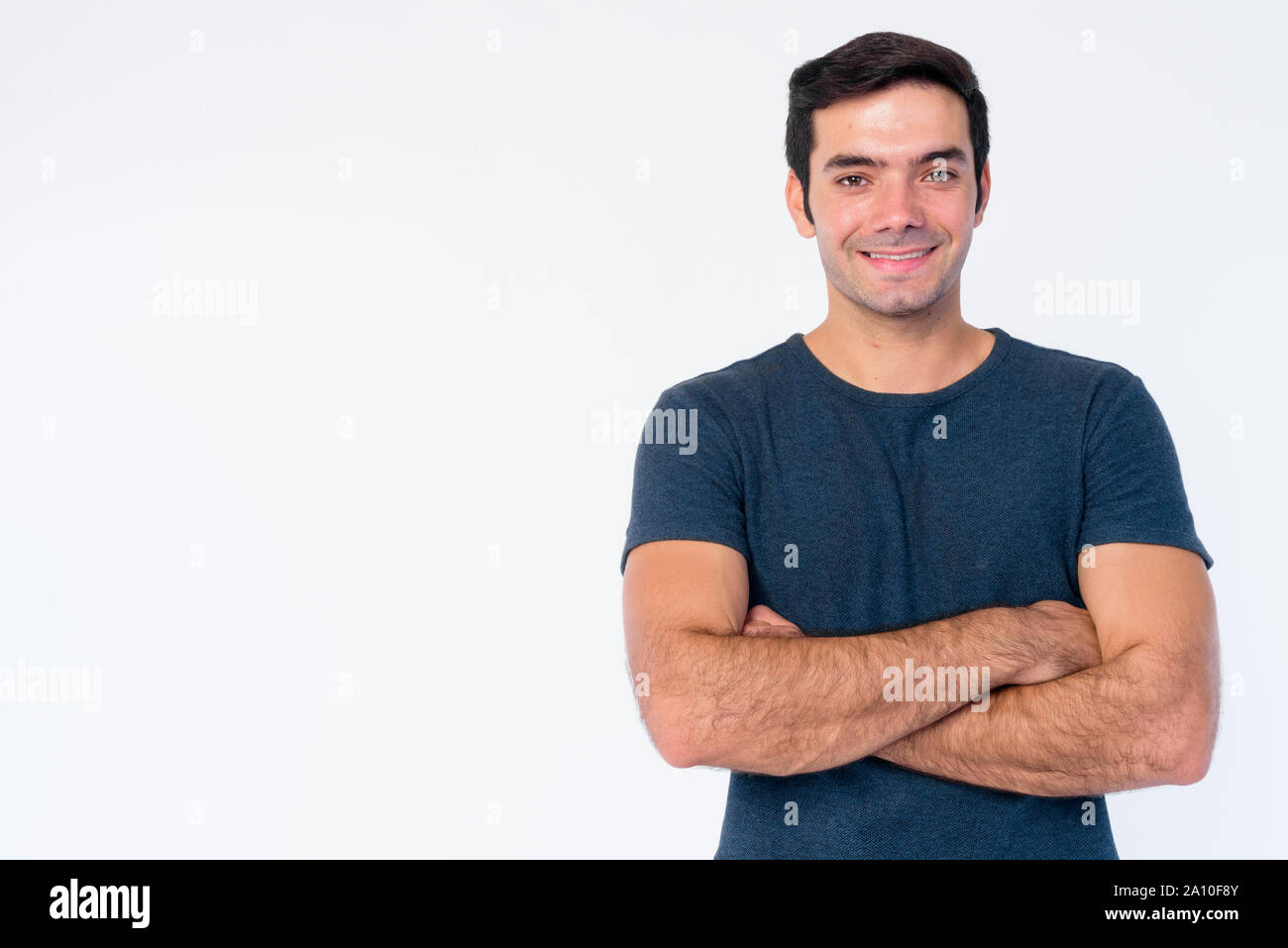Portrait of happy young handsome Persian man with arms crossed Stock ...